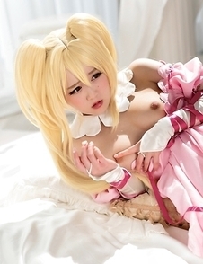 Stunning Japanese Ria Kurumi dressed as a doll masturbates with a vibrator on the bed