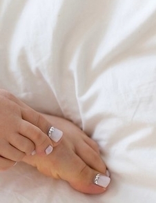 Aya Kisaki shows her toes while stroking this dude's throbbing boner