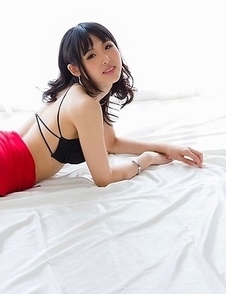 Natsuki Yokoyama posing in a red skirt with black stockings, showing her ass