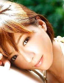 Japanese Yumiko Shaku  in orange bath suit takes a walk on the beach