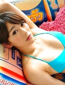 Shou Nishino in blue bath suit sits with ass up in the air