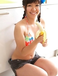 Sweet Ayana Tanigaki smiles and poses at the kitchen with banana