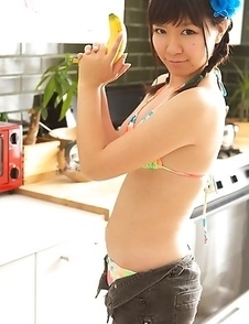 Sweet Ayana Tanigaki smiles and poses at the kitchen with banana