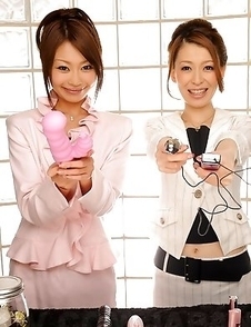 Yuri and Yu posing with sex toys