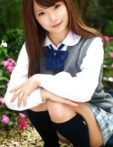 Manami Sato in short uniform skirt spends time in the park