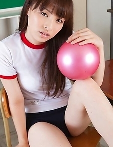 Maho Kiruma in sports equipment plays with ball on desk