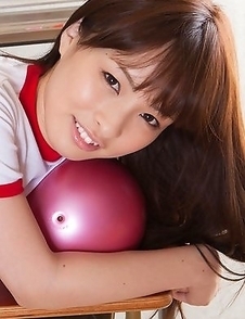 Maho Kiruma in sports equipment plays with ball on desk