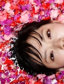 Airi Suzuki in bath suit enjoys petals all over her body