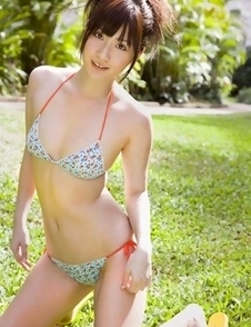 Anna Nakagawa in bath suit is playful next to the pool