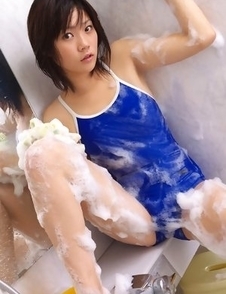Airi Sakuragi puts soap and shower on body over bath suit
